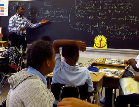 General Education Teacher Bryson Green of Teach for America leads his fifth-grade students in a discussion about stereotypes at Carver Academy. (Photo by Rick Brown)