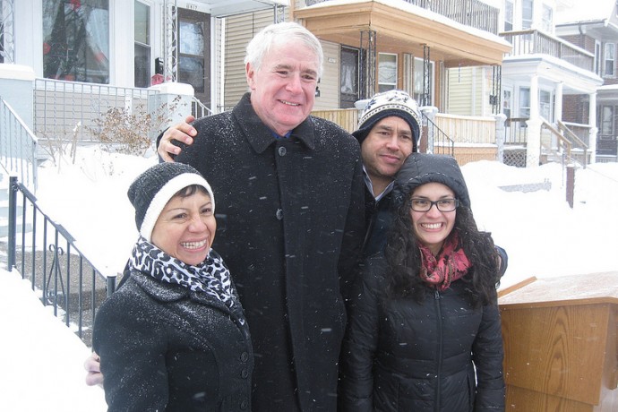 Milwaukee Mayor Tom Barrett shares a laugh with homeowner Marisela Martin, 12th District Alderman José Pérez and another woman after a press conference on the 1800 block of West Arthur Avenue. (Photo by Brendan O’Brien)