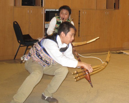 Hmong-American children perform with qeejs, reed pipe instruments. (Photo by Rick Brown)