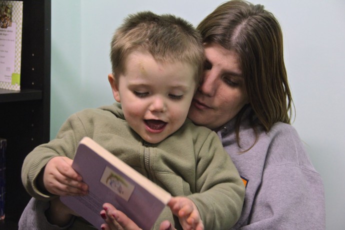 Meta House client Denise and her son, Timothy, were two of more than 20 people on hand for the opening of a new reading room at the facility that treats women for drug and alcohol addiction. (Photo by Karen Slattery)