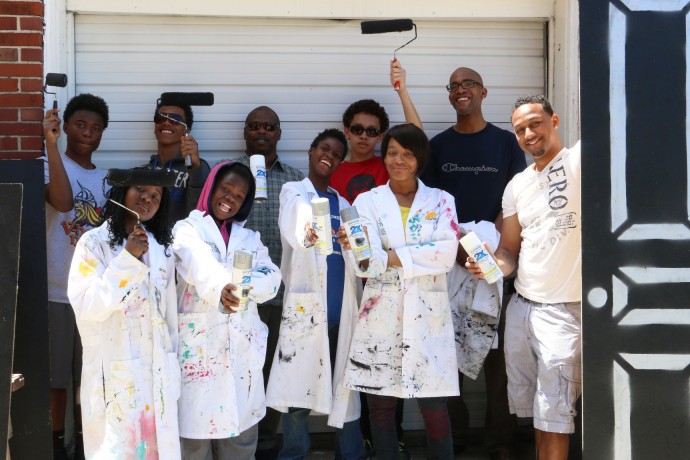 A group of Amani residents participate in ‘Painting with a Purpose,” a youth development program that decorates vacant houses. (Photo by Stanford Brookshire)