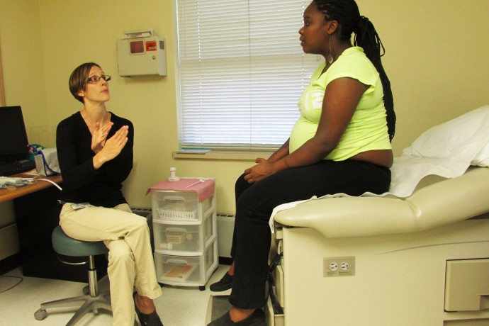 Nurse Practitioner Kathlyn Albert discusses delivery date details with patient Endasia Alli during an appointment at the Marquette Neighborhood Health Center in the Hillside Family Resource Center. (Photo by Kara Chiuchiarelli)