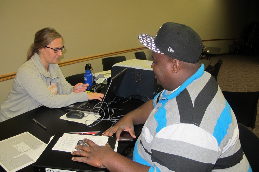 Jermaine Jackson works with Angela Catania, a supervisor at the Center for Driver’s License Recovery and Employability, to check his driving status. 