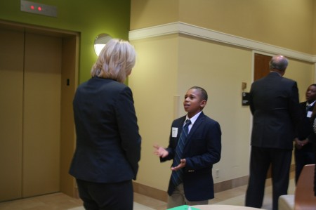Montavion Pewitt, 11, engages one of The Great Handshake judges. (Photo by Jabril Faraj)