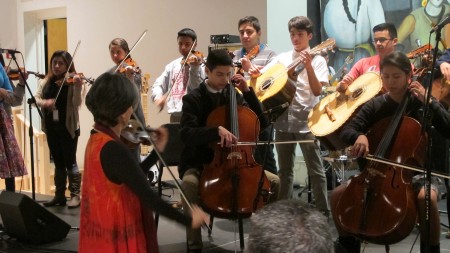 Dinorah Marquez conducts students in the Latino Arts Strings Program in a performance at the United Community Center.  (Photo by Andrea Waxman)