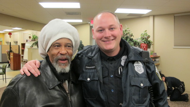 Washington Park resident Don Balentine (left) and Officer Steve Osmanski of the Milwaukee Police Department attended the recent annual gathering at Washington Park Partners. (Photo by Andrea Waxman)