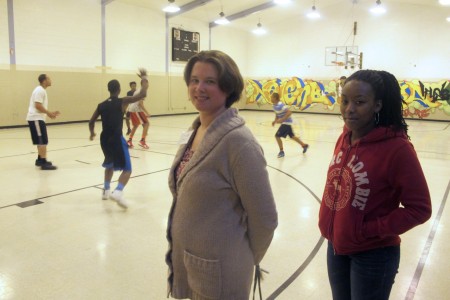 Anna Bierer, director of programming at Neighborhood House, and Maya McCullough hang out during a pick-up game. (Photo by Edgar Mendez)