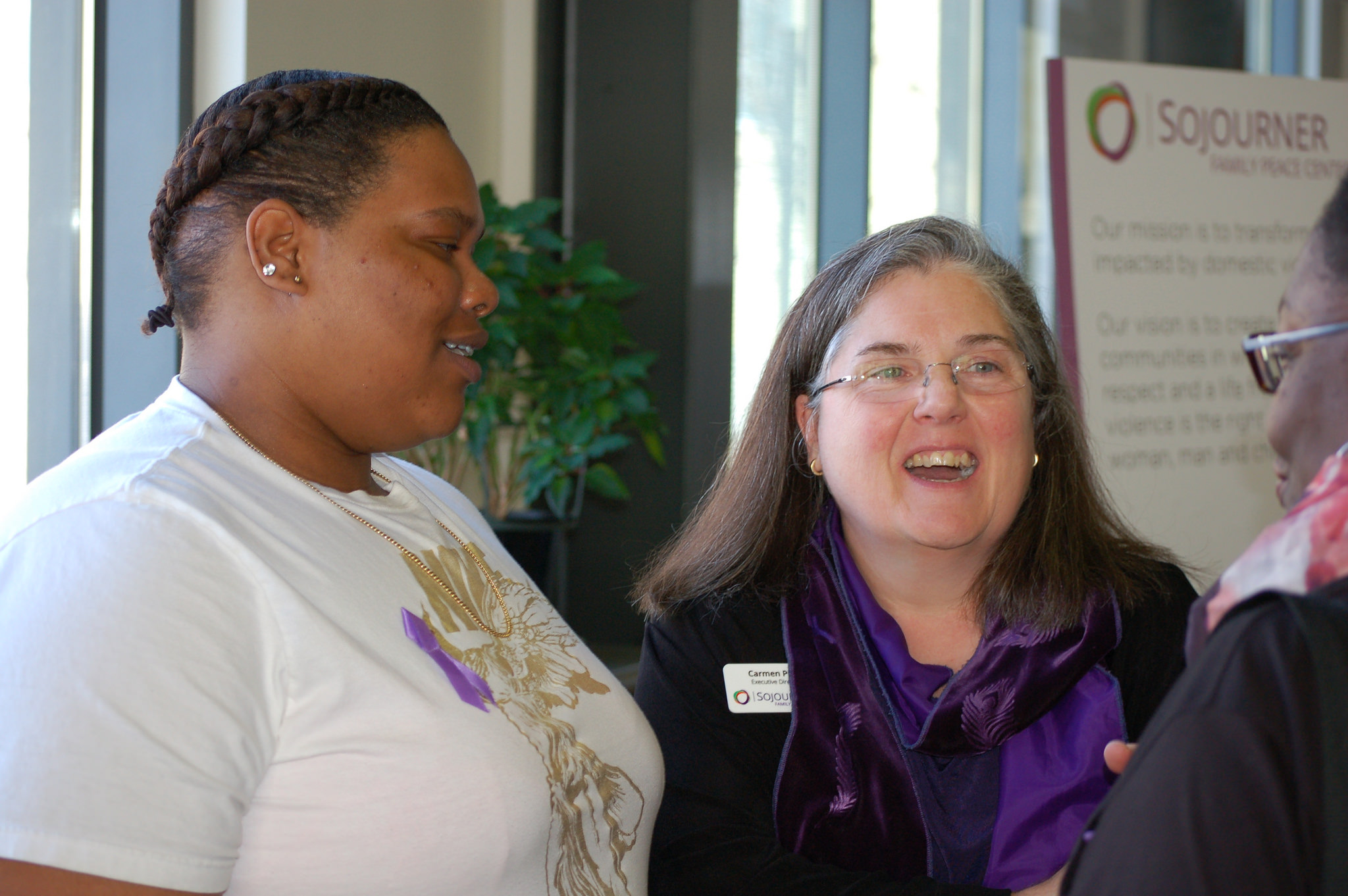 Garada (left), who requested that her last name not be used, shares a light moment with Carmen Pitre (center), executive director of Sojourner Family Peace Center, and Dolly Grimes-Johnson, shelter and services director. (Photo by Andrea Waxman) 