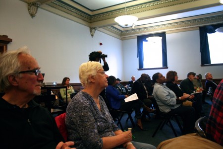 Bill Sell (left), Joyce Ellwanger (second from left) and others look on during the budget session at Milwaukee Public Library's Centennial Hall. (Photo by Jabril Faraj)