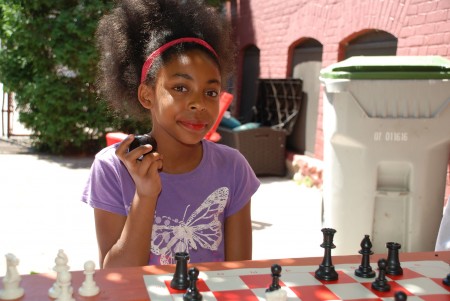 Quan Caston named fifth-grader Elana Sinclair “Chess Student of the Summer” for being a self-starter with an excellent attitude. (Photo by Andrea Waxman)