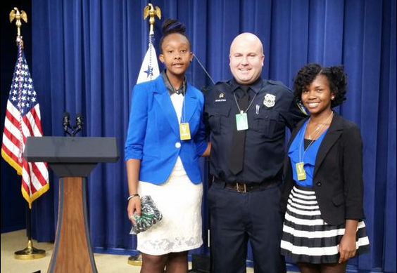 Photo: Mills (left) with Officer Singleton and Erica Lofton, courtesy of Girls in Action on Twitter (@girlsinaction3)
