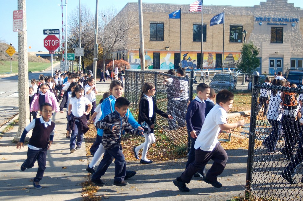 Bruce Guadalupe Community School students rush to the playground in Walker Square Park during recess. (Photo by Edgar Mendez)