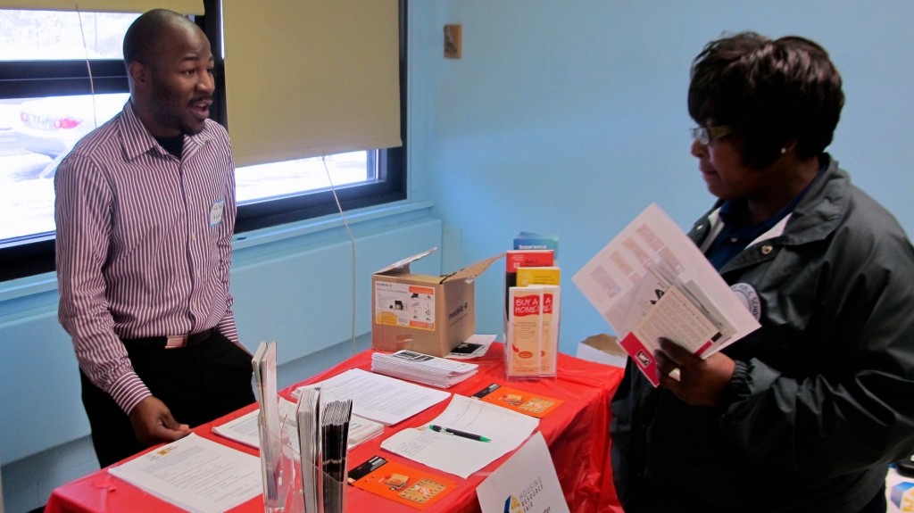 Rick Banks (left) of Harambee Great Neighborhood Initiative was one of many community leaders available at the housing fair to help residents improve their neighborhoods through home ownership. (Photo by Wyatt Massey) 