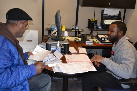 A volunteer tax preparer works with a client at SDC's Teutonia site. (Photo courtesy of SDC)