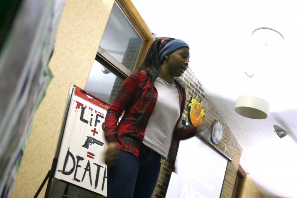Kaliah Hughes-Bester, 15, performs a poem she wrote called 'Behind the Gun.' (Photo by Jabril Faraj)