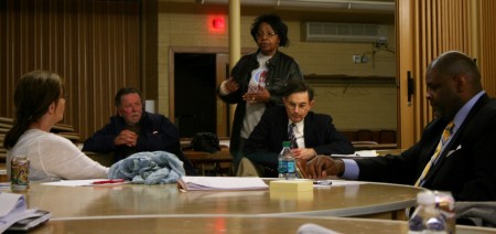 Marva Herndon addresses Debra Jupka (left), Demond Means (right) and others at the advisory committee meeting. (Photo by Jabril Faraj)