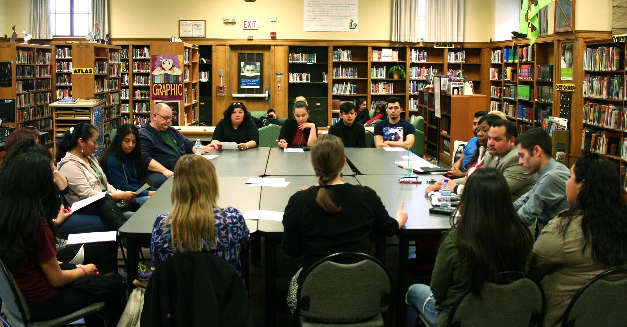 A group of staff, parents and students meet at the Pulaski library. (Photo by Jabril Faraj)