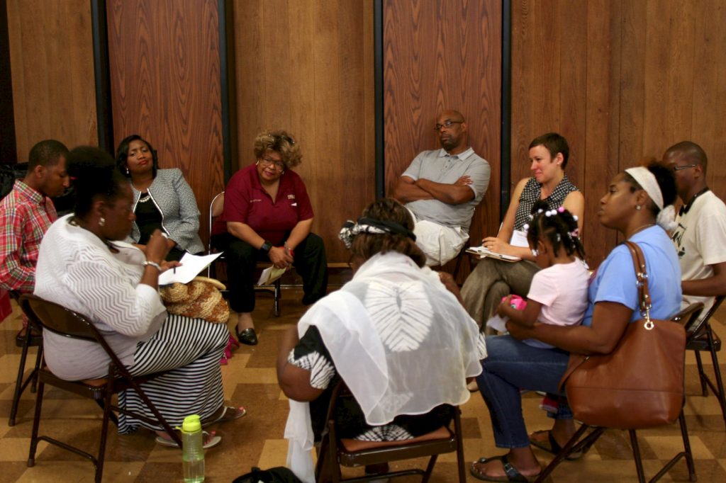 Attendees share stories in discussion circles during a recent listening session on police-community relations. (Photo by Jabril Faraj)