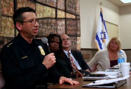 MPD Assistant Police Chief James Harpole (left) speaks briefly during the panel discussion, as Iris Roley, Al Gerhardstein and Kathy Harrell, all from Cincinnati, look on. (Photo by Jabril Faraj)