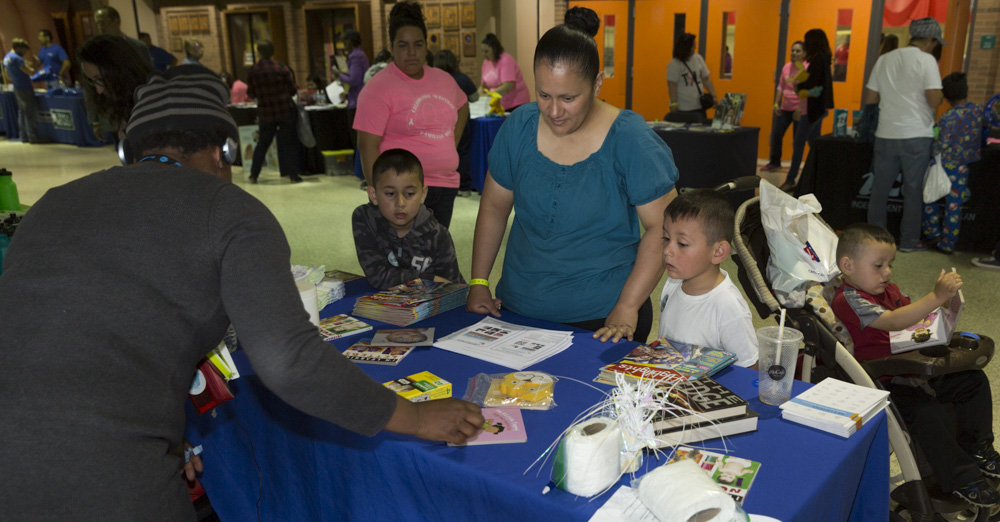 Attendees visit a resource table during the 2018 Celebrando Nuestras Familias event. 