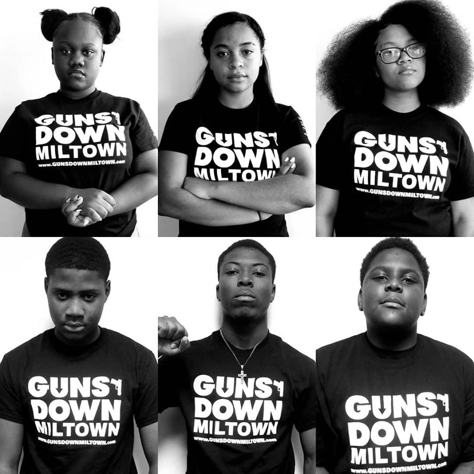Teens wearing t-shirts emblazoned with Guns Down Miltown logo