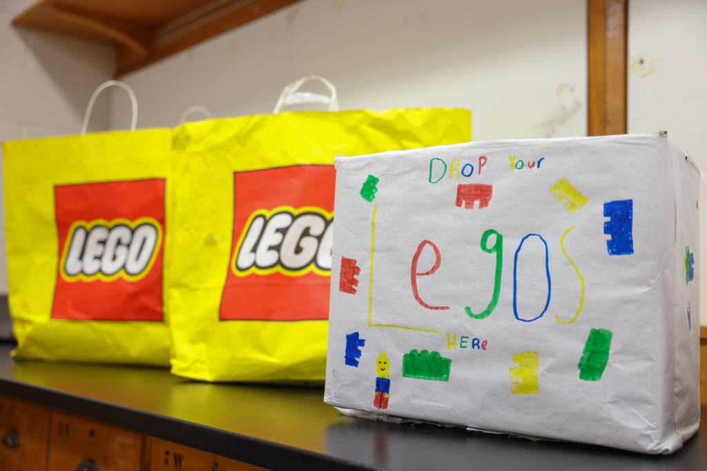 A white box decorated with colorful drawings and the text