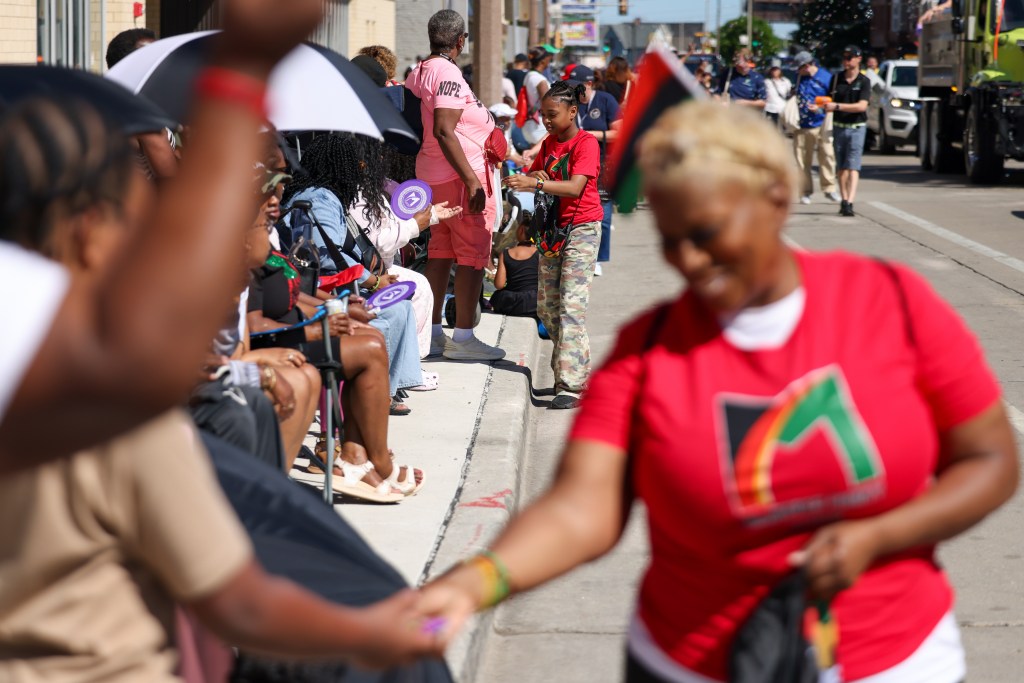Attendees get candy during the 55th Juneteenth Jubilee Parade on Friday, June 19, 2026 in Milwaukee. (Photo by Jonathan Aguilar / Milwaukee Neighborhood News Service / CatchLight Local)