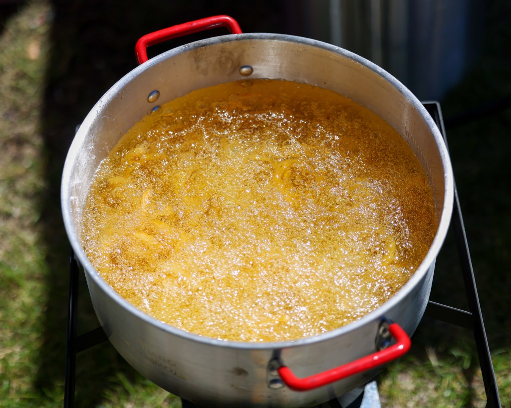 Onions rings fry in a pot during the 55th Juneteenth Jubilee Parade on Friday, June 19, 2026 in Milwaukee. (Photo by Jonathan Aguilar / Milwaukee Neighborhood News Service / CatchLight Local)