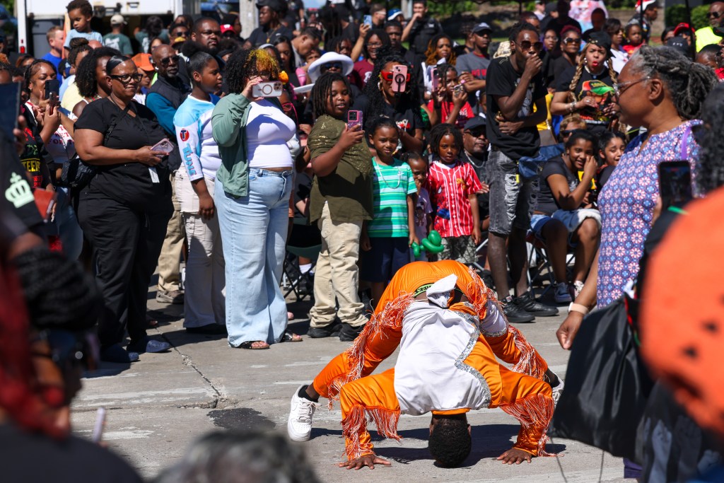 A participant of the parade dances during the 55th Juneteenth Jubilee Parade on Friday, June 19, 2026 in Milwaukee. (Photo by Jonathan Aguilar / Milwaukee Neighborhood News Service / CatchLight Local)