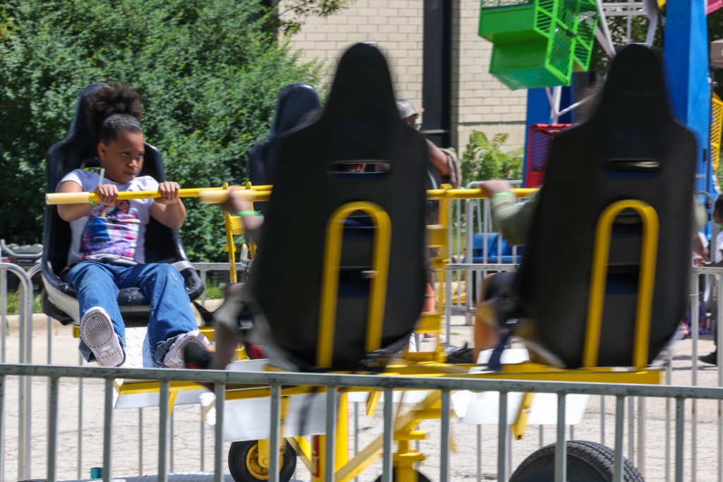 A child rides on an amusement ride during the 55th Juneteenth Jubilee Parade on Friday, June 19, 2026 in Milwaukee. (Photo by Jonathan Aguilar / Milwaukee Neighborhood News Service)