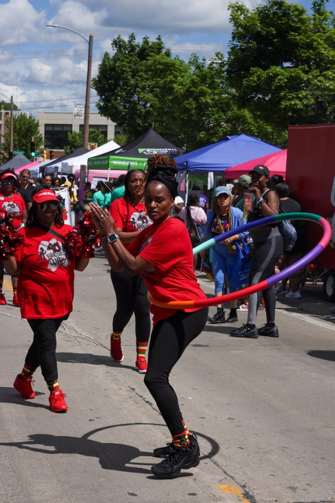 A person hula-hoops down the street during the 55th Juneteenth Jubilee Parade on Friday, June 19, 2026 in Milwaukee. (Photo by Jonathan Aguilar / Milwaukee Neighborhood News Service / CatchLight Local)