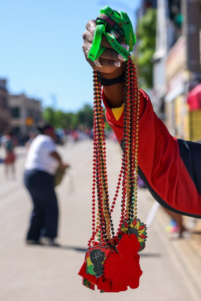 A person holds up beaded necklaces during the 55th Juneteenth Jubilee Parade on Friday, June 19, 2026 in Milwaukee. (Photo by Jonathan Aguilar / Milwaukee Neighborhood News Service / CatchLight Local)