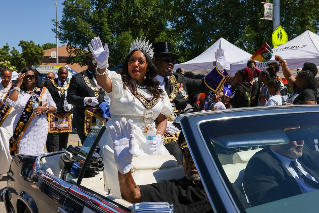 People wave from a car during the 55th Juneteenth Jubilee Parade on Friday, June 19, 2026 in Milwaukee. (Photo by Jonathan Aguilar / Milwaukee Neighborhood News Service / Catchlight Local)