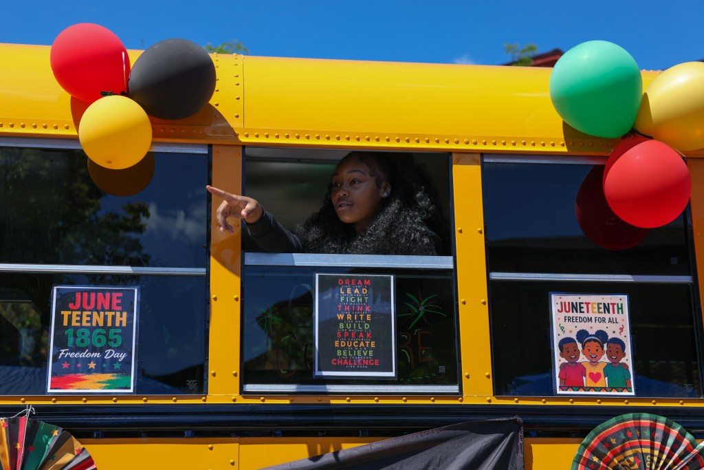 A person rides a bus during the 55th Juneteenth Jubilee Parade on Friday, June 19, 2026 in Milwaukee. (Photo by Jonathan Aguilar / Milwaukee Neighborhood News Service / CatchLight Local)