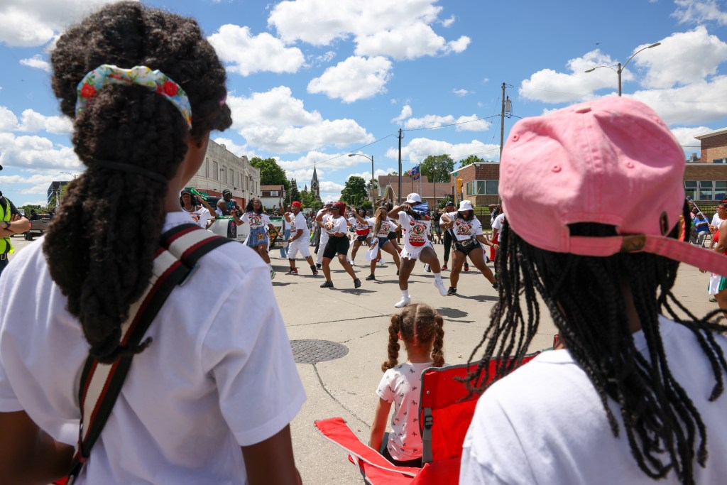 Children watch as performers dance during the 55th Juneteenth Jubilee Parade on Friday, June 19, 2026 in Milwaukee. (Photo by Jonathan Aguilar / Milwaukee Neighborhood News Service / CatchLight Local)