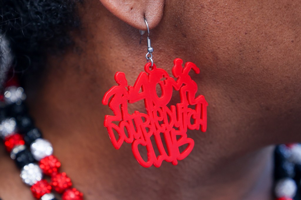 A red earring reading